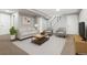 Finished basement with a couch, two chairs, TV and staircase at 118 S Yates Way, Denver, CO 80219