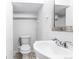 Cozy bathroom featuring a modern toilet, sink, and chrome fixtures with neutral walls and a small mirror at 118 S Yates Way, Denver, CO 80219