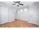 Neutral bedroom features hardwood floors, a modern ceiling fan, and closet and storage space at 118 S Yates Way, Denver, CO 80219