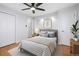 Bright bedroom features a ceiling fan, hardwood floors and a well-lit closet/storage area at 118 S Yates Way, Denver, CO 80219