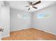 Bright bedroom featuring hardwood floors, two windows with natural light, and a modern ceiling fan at 118 S Yates Way, Denver, CO 80219