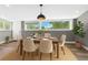 Cozy dining room features modern lighting, a table set for six, and a large window at 118 S Yates Way, Denver, CO 80219