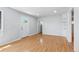 Bright living room featuring hardwood floors and neutral paint, with a view to adjacent rooms at 118 S Yates Way, Denver, CO 80219