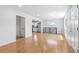 Open-concept living room featuring hardwood floors and views to stainless steel appliances in the kitchen at 118 S Yates Way, Denver, CO 80219
