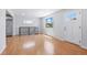Bright living room featuring wood floors, lots of windows and a white door at 118 S Yates Way, Denver, CO 80219