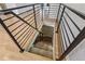 Modern staircase leading to the lower level with metal railings and hardwood flooring at 118 S Yates Way, Denver, CO 80219