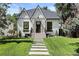 Charming white brick home with a black roof and manicured lawn at 1655 S Marion, Denver, CO 80210