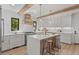 Modern kitchen with white cabinets, a large island, and wooden beams at 1655 S Marion, Denver, CO 80210