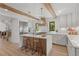 Modern kitchen with white cabinets, a large island, and wooden beams at 1655 S Marion, Denver, CO 80210