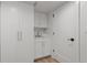 Bright laundry room with built-in cabinets and sink at 1655 S Marion, Denver, CO 80210