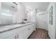 Double vanity bathroom with granite countertop and white cabinets at 3987 N Riviera Ct, Aurora, CO 80019