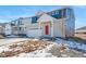 Two-story home with blue siding, red door, and a two-car garage at 3987 N Riviera Ct, Aurora, CO 80019