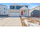 Two-story home with blue siding, red door, and a two-car garage at 3987 N Riviera Ct, Aurora, CO 80019