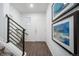 Modern foyer featuring hardwood floors and a staircase at 3987 N Riviera Ct, Aurora, CO 80019