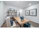 Home office with a large wood desk and shelving at 3987 N Riviera Ct, Aurora, CO 80019