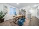 Bright home office with wood desk and blue ottomans at 3987 N Riviera Ct, Aurora, CO 80019