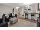 Open-concept living area featuring a modern kitchen with stainless steel appliances and black countertops at 7040 E Girard Ave # 310, Denver, CO 80224