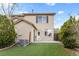 A home's backyard features green artificial turf grass and partial view of home's exterior at 12798 Ivy St, Thornton, CO 80602