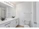Bright bathroom featuring a dual-sink vanity with black hardware and a shower over tub at 12798 Ivy St, Thornton, CO 80602