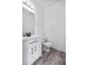 Bathroom featuring wood-style flooring, vanity with a matte black faucet and a toilet at 12798 Ivy St, Thornton, CO 80602