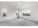 Bright bedroom with large windows, neutral carpet, and a ceiling fan, offering a serene retreat at 12798 Ivy St, Thornton, CO 80602