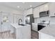 Well-lit kitchen with white cabinets, stainless steel appliances, and a trendy island, perfect for cooking and entertaining at 12798 Ivy St, Thornton, CO 80602