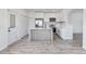 Modern kitchen featuring sleek white cabinets, stainless steel appliances, and a stylish center island at 12798 Ivy St, Thornton, CO 80602