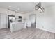 Open-concept kitchen featuring a modern island, stainless steel appliances, and bright white cabinetry for a contemporary feel at 12798 Ivy St, Thornton, CO 80602