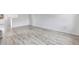 Spacious, minimalist living area with neutral tones, light wood flooring, and ample natural light at 12798 Ivy St, Thornton, CO 80602