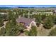 Rear aerial view of a single-Gathering home featuring a deck with views of a wooded area at 19050 Archers Dr, Monument, CO 80132