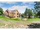 Spacious backyard with a playset, storage shed, and ample lawn space perfect for outdoor activities at 19050 Archers Dr, Monument, CO 80132