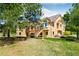 Spacious backyard with mature trees, a deck, a walk-out basement and ample space for outdoor activities at 19050 Archers Dr, Monument, CO 80132