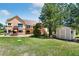 Expansive backyard featuring a storage shed, playset, and lush lawn at 19050 Archers Dr, Monument, CO 80132
