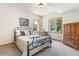 Comfortable bedroom with scenic views from the two windows and furnished with antique style furniture at 19050 Archers Dr, Monument, CO 80132