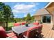 Outdoor deck with a table, chairs, and a peaceful view of the surrounding trees at 19050 Archers Dr, Monument, CO 80132