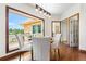 Open-concept dining room featuring picture window offering scenic exterior views and contemporary light fixture at 19050 Archers Dr, Monument, CO 80132