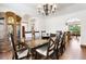A spacious dining room with a large table, seating for eight, a hutch and a decorative chandelier at 19050 Archers Dr, Monument, CO 80132