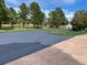 A long black newly paved driveway with an adjacent cement walkway leading to a well manicured lawn at 19050 Archers Dr, Monument, CO 80132