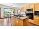 Eat-in kitchen with stainless steel appliances, center island, and breakfast nook with backyard views at 19050 Archers Dr, Monument, CO 80132