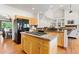 Spacious eat-in kitchen with island, stainless steel appliances, and hardwood floors throughout at 19050 Archers Dr, Monument, CO 80132