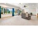Spacious living room with ample natural light, a ceiling fan, and sliding glass doors to the outdoors at 19050 Archers Dr, Monument, CO 80132