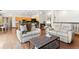 Spacious living room and kitchen featuring hardwood floors, modern furnishings, and a vaulted ceiling at 19050 Archers Dr, Monument, CO 80132