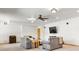 Living room featuring a ceiling fan, plush armchairs, and a mounted TV at 19050 Archers Dr, Monument, CO 80132