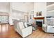 Bright living room with vaulted ceilings, hardwood floors and fireplace feature with built-in shelving at 19050 Archers Dr, Monument, CO 80132