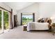 Bright bedroom with large windows and view, with a desk, and carpeted floors at 19050 Archers Dr, Monument, CO 80132