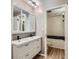 Modern bathroom with a double sink vanity, updated fixtures, and a clean, bright bathtub/shower combo at 937 N Clarkson St # 206, Denver, CO 80218