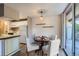 Cozy dining area with a classic round table, stylish chairs, and access to a balcony with natural light at 937 N Clarkson St # 206, Denver, CO 80218