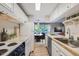 Efficient kitchen with classic cabinets, stainless steel appliances, and an open view to the dining area at 937 N Clarkson St # 206, Denver, CO 80218
