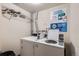 Efficient laundry room featuring two washing machines and detailed instructional signage at 937 N Clarkson St # 206, Denver, CO 80218