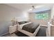 Serene main bedroom featuring a comfortable bed, soft lighting, and a large window with natural light at 937 N Clarkson St # 206, Denver, CO 80218